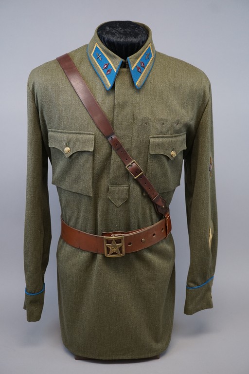A uniform with a belt

Description automatically generated