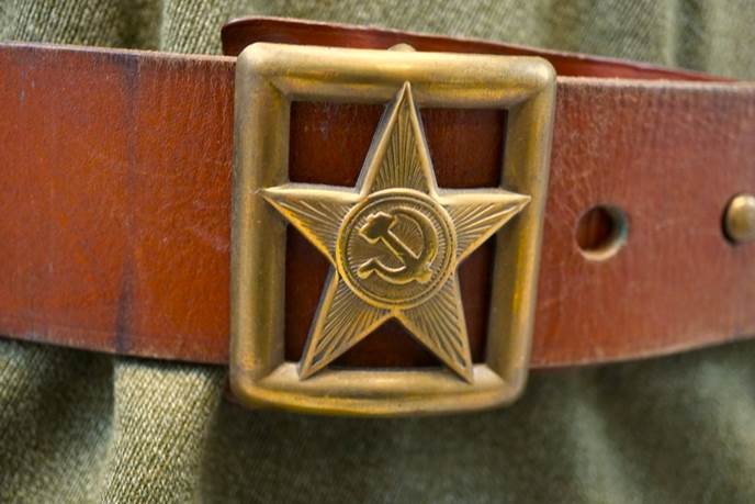 A belt with a star and hammer and sickle

Description automatically generated