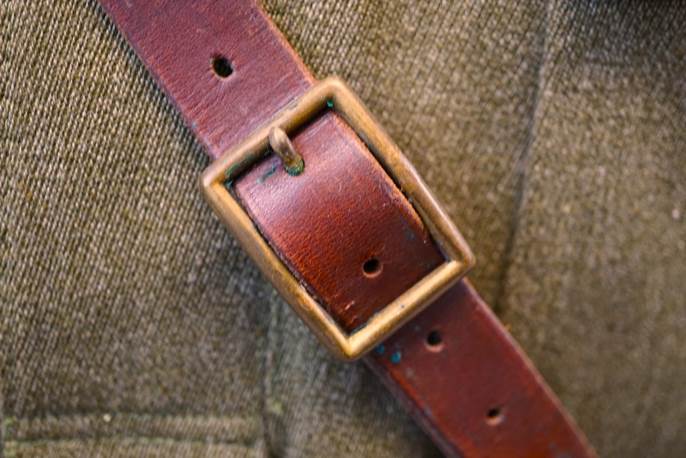A brown leather belt with a buckle

Description automatically generated