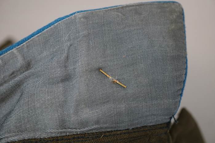 A needle in a piece of fabric

Description automatically generated
