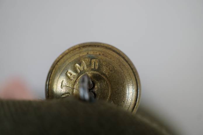Close-up of a button with a key

Description automatically generated