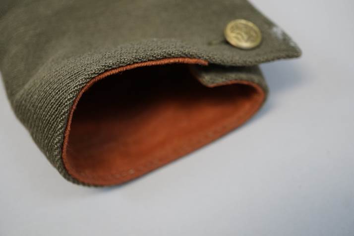 A close-up of a green pouch

Description automatically generated