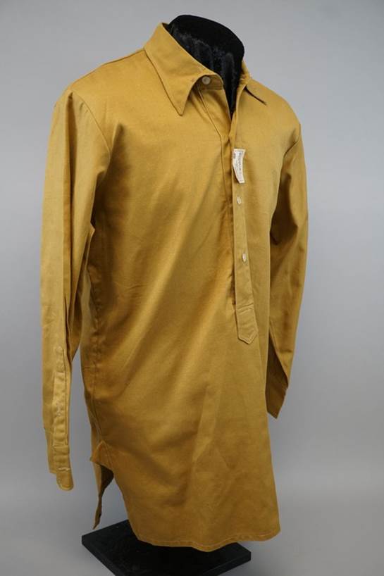 A yellow shirt on a mannequin

Description automatically generated