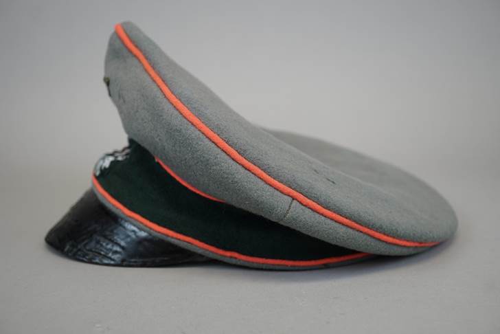 A grey hat with orange stripe

Description automatically generated