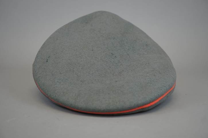 A grey hat with orange stripe

Description automatically generated