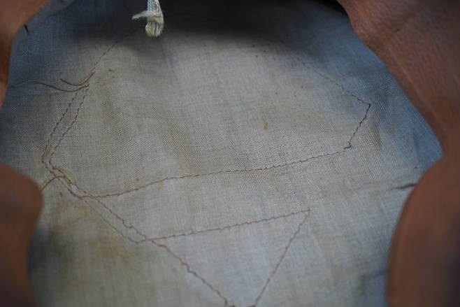 A close-up of a fabric with a stitching

Description automatically generated