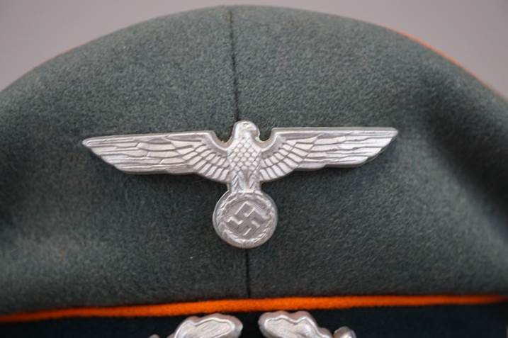 A close-up of a hat with a symbol

Description automatically generated