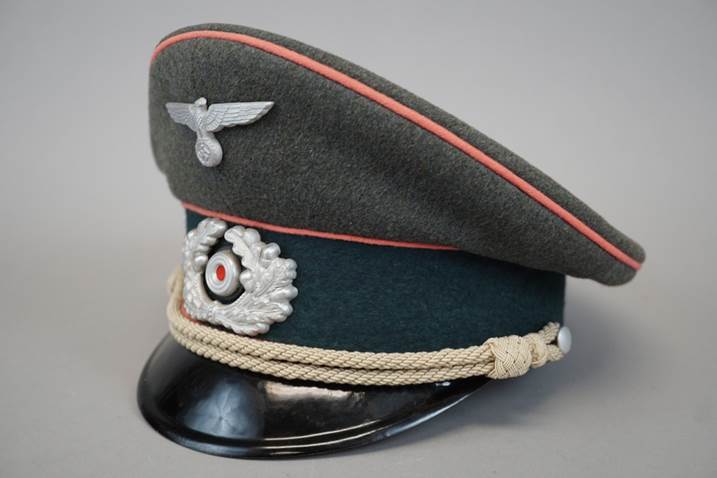 A military hat with a white and red band

Description automatically generated