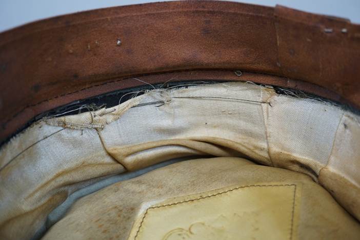 A close-up of a leather hat

Description automatically generated