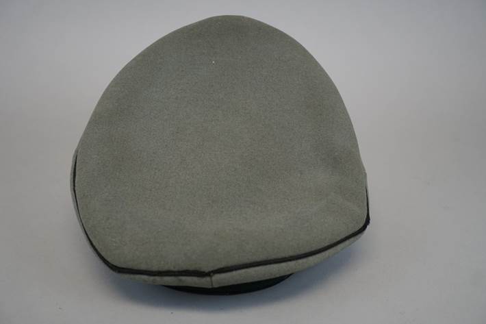 A grey hat with black trim

Description automatically generated