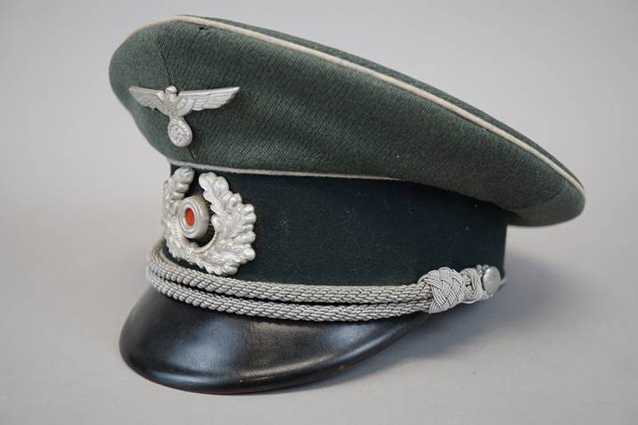 A green hat with silver accents

Description automatically generated