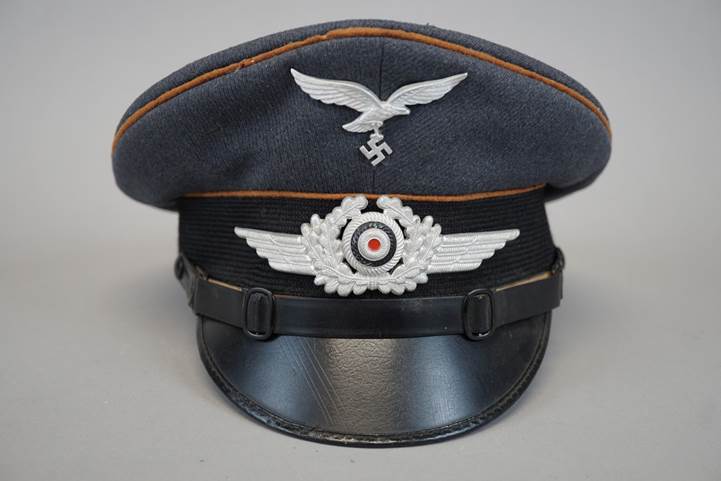 A black hat with a white emblem

Description automatically generated