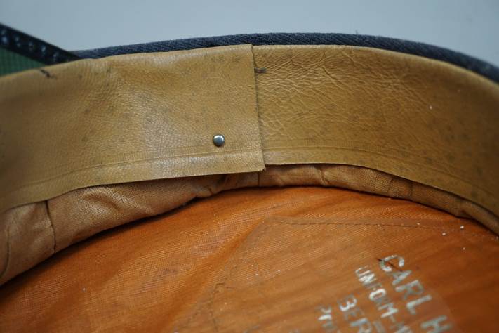 A close-up of a leather collar

Description automatically generated