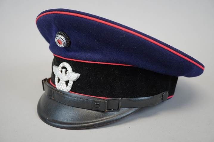 A blue and black hat with a white and red stripe

Description automatically generated