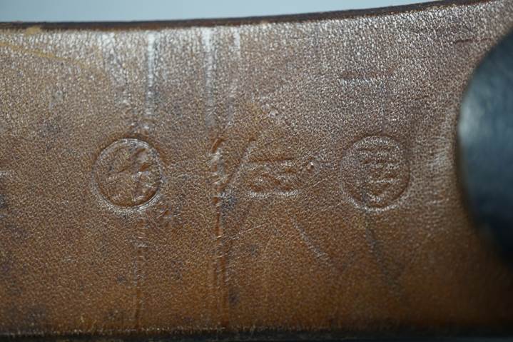 A close-up of a leather belt

Description automatically generated