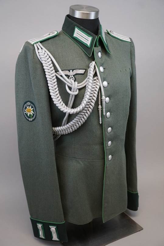 A military uniform with a white rope

Description automatically generated
