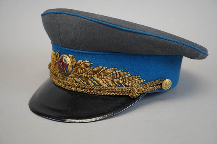 A blue and black hat with gold trim

Description automatically generated