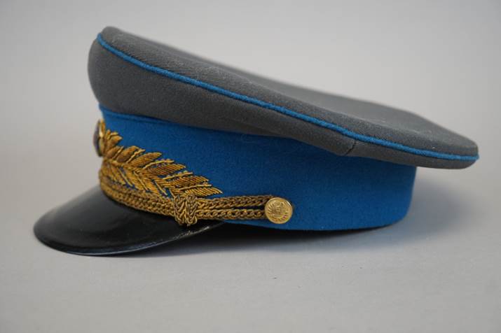 A blue and grey hat with gold trim

Description automatically generated