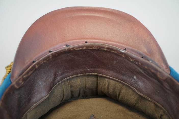 A brown leather cushion with stitching

Description automatically generated
