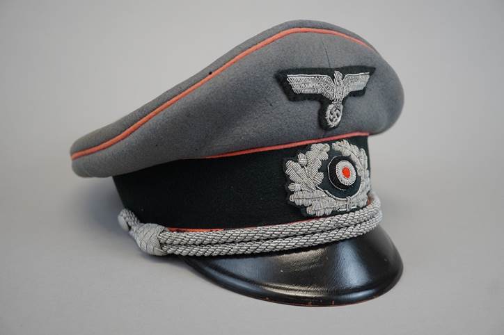 A grey hat with a red and black patch

Description automatically generated