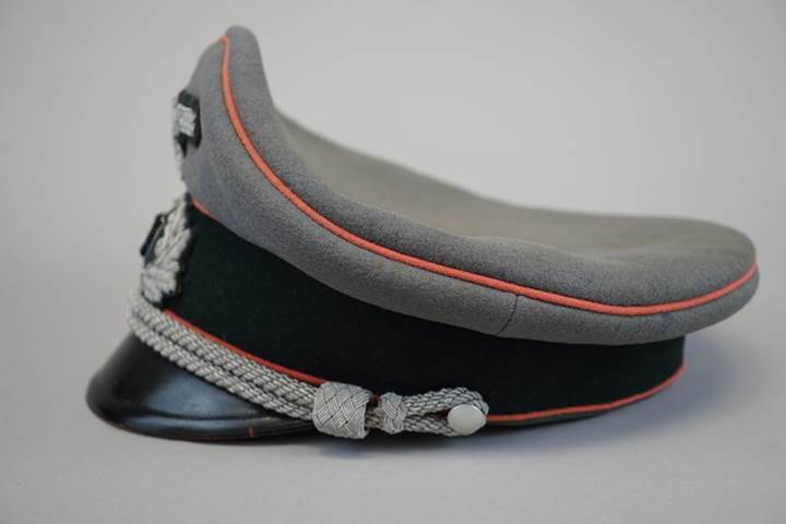 A grey hat with red and black trim

Description automatically generated