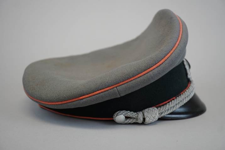 A grey hat with orange trim

Description automatically generated