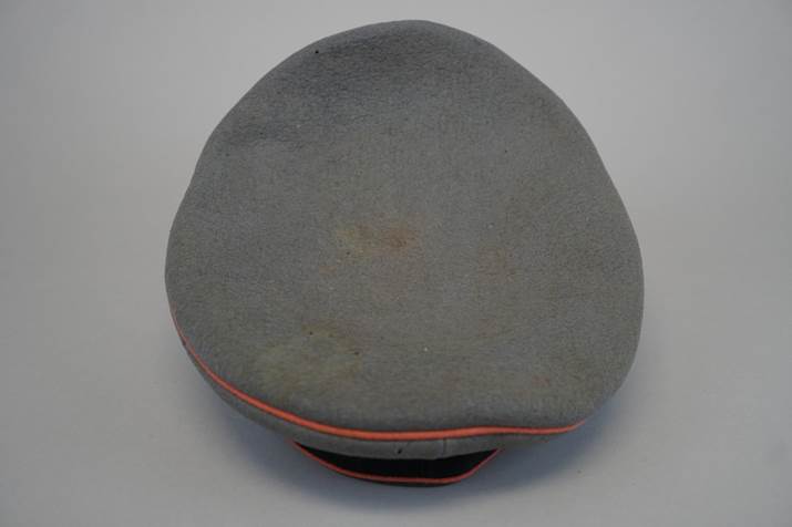 A grey hat with orange trim

Description automatically generated