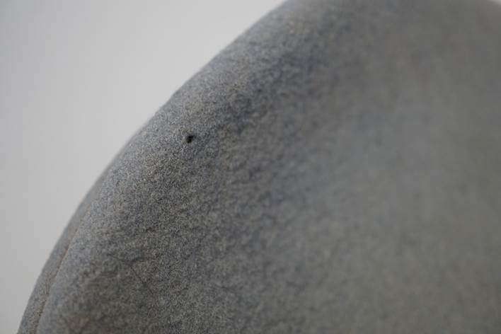 Close-up of a grey surface

Description automatically generated