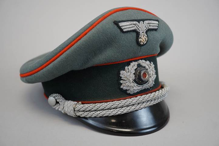 A military hat with a logo on it

Description automatically generated