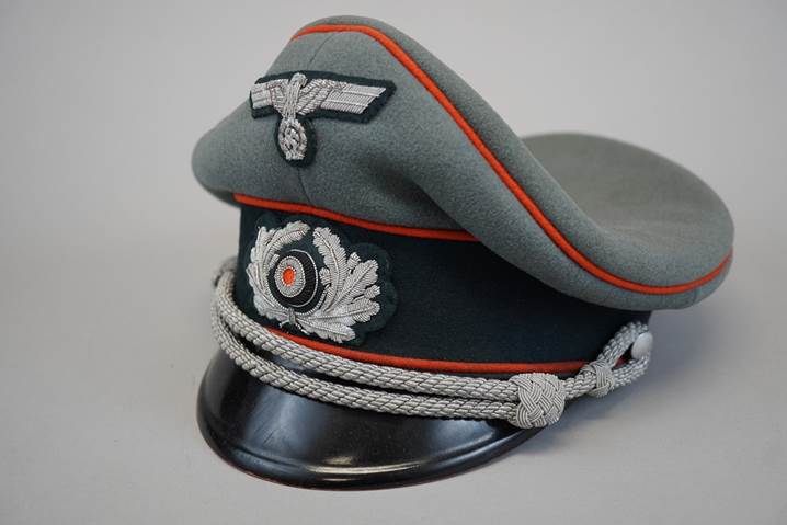 A grey hat with a red and black band

Description automatically generated