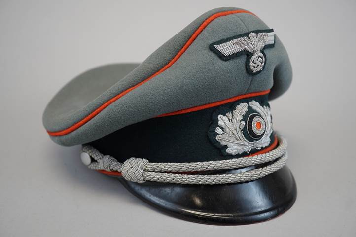 A grey hat with a red and black band

Description automatically generated