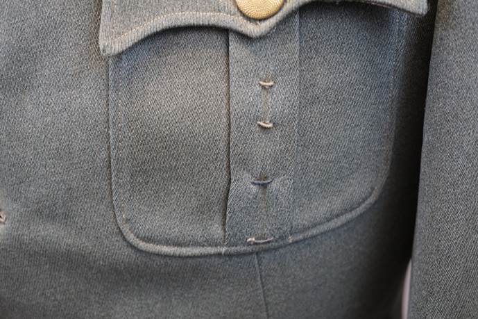 Close-up of a military uniform pocket

Description automatically generated