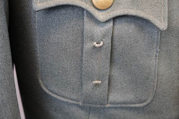 Close-up of a buttoned shirt

Description automatically generated