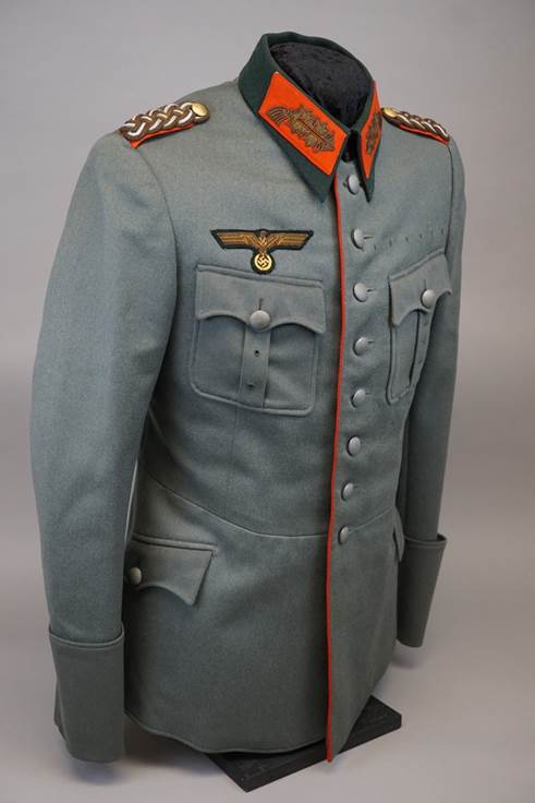 A gray military uniform with orange accents

Description automatically generated