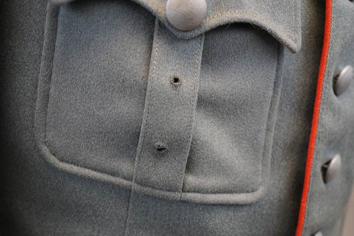 A close-up of a buttoned shirt

Description automatically generated