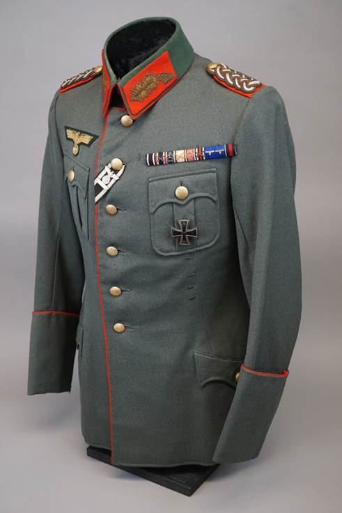 A military uniform with patches on the front

Description automatically generated