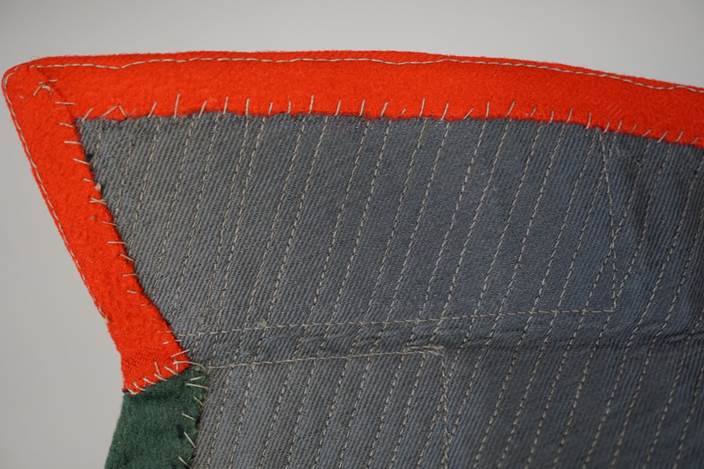 Close-up of a grey and red fabric

Description automatically generated