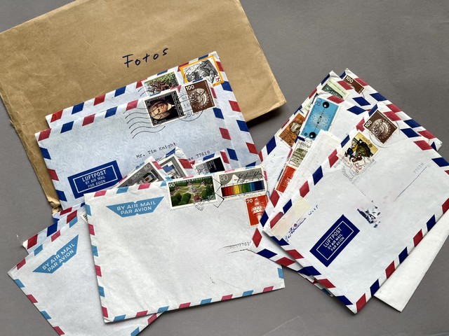 Several envelopes with stamps

Description automatically generated