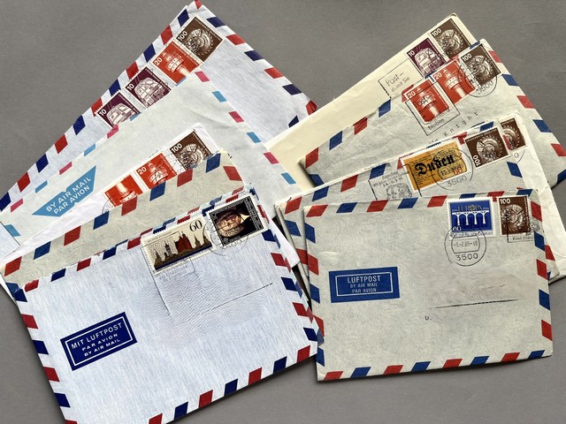 Several envelopes with stamps

Description automatically generated