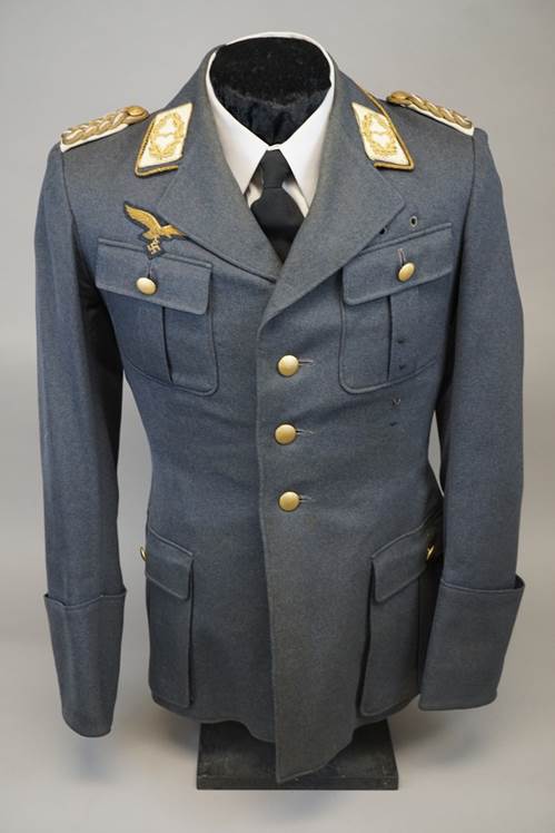 A uniform with gold patches on the chest

Description automatically generated