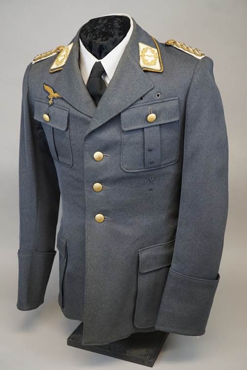 A uniform with gold patches on the front

Description automatically generated