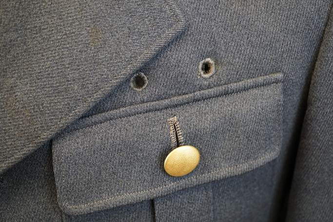 A close-up of a button on a jacket

Description automatically generated