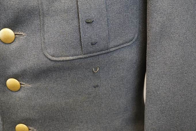 Close-up of a buttoned shirt

Description automatically generated