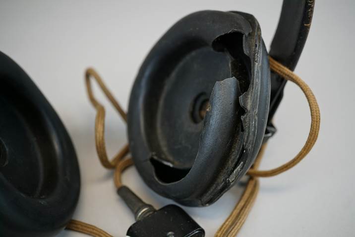 A broken headphone with a cord

Description automatically generated