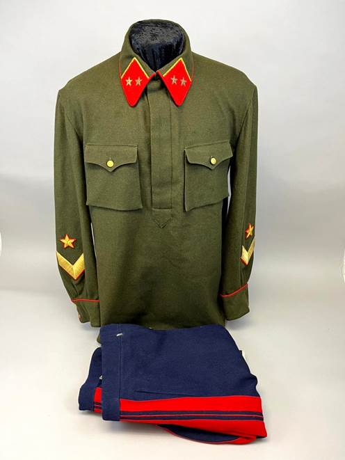 A uniform with red collars and a blue and red blanket

Description automatically generated