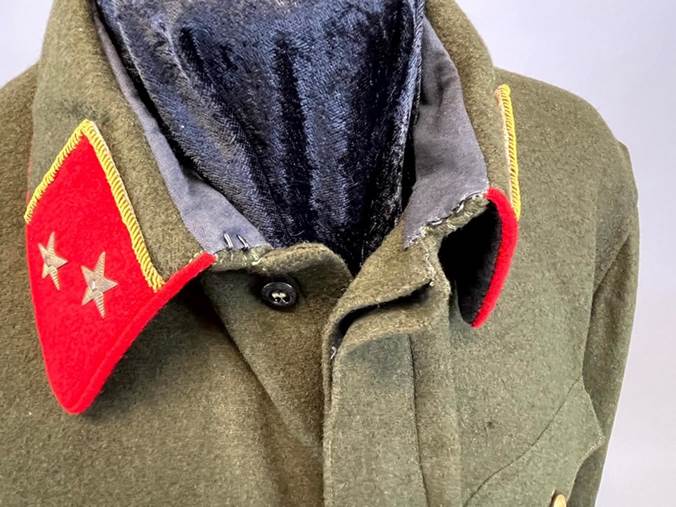 A close-up of a military jacket

Description automatically generated