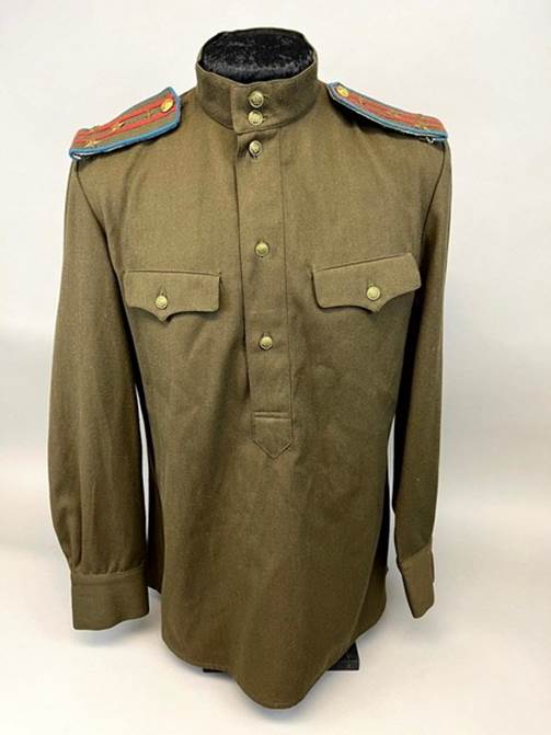 A green military uniform with a collar

Description automatically generated with medium confidence