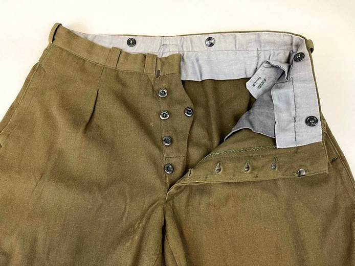 A pair of pants with buttons

Description automatically generated