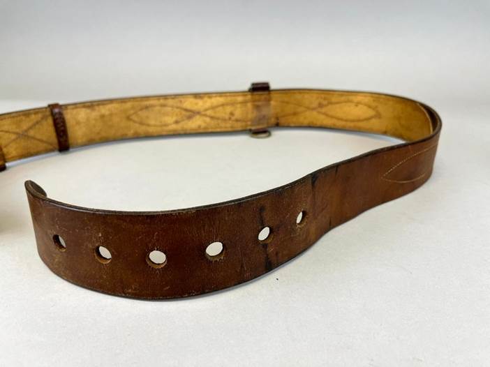 A brown leather belt with holes

Description automatically generated