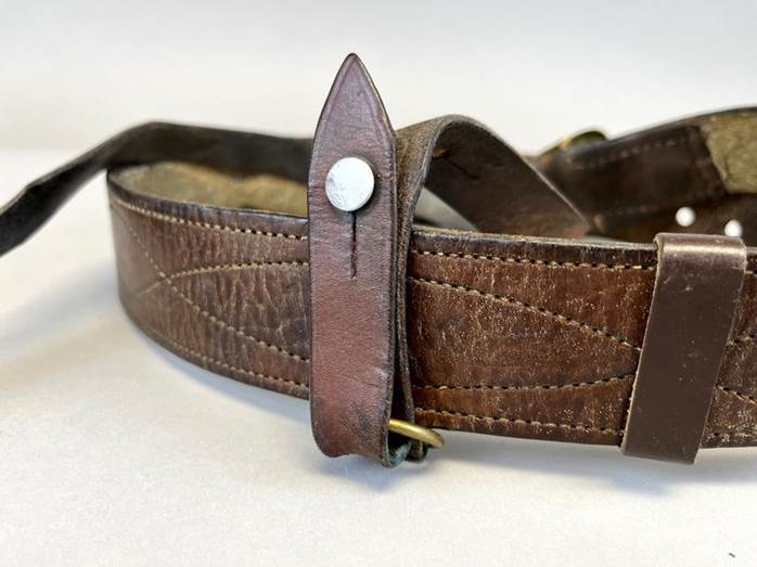 A brown leather belt with a buckle

Description automatically generated